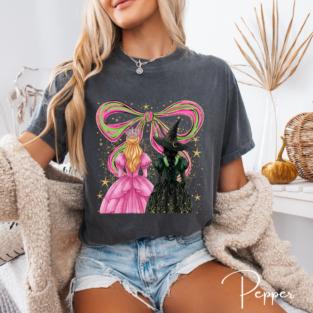 ✨ Wicked Besties Comfort Colors 1717 Tee 💚💗 | Sparkly Hand-Drawn Elphaba & Glinda with Coquette Bow 🎀🌙